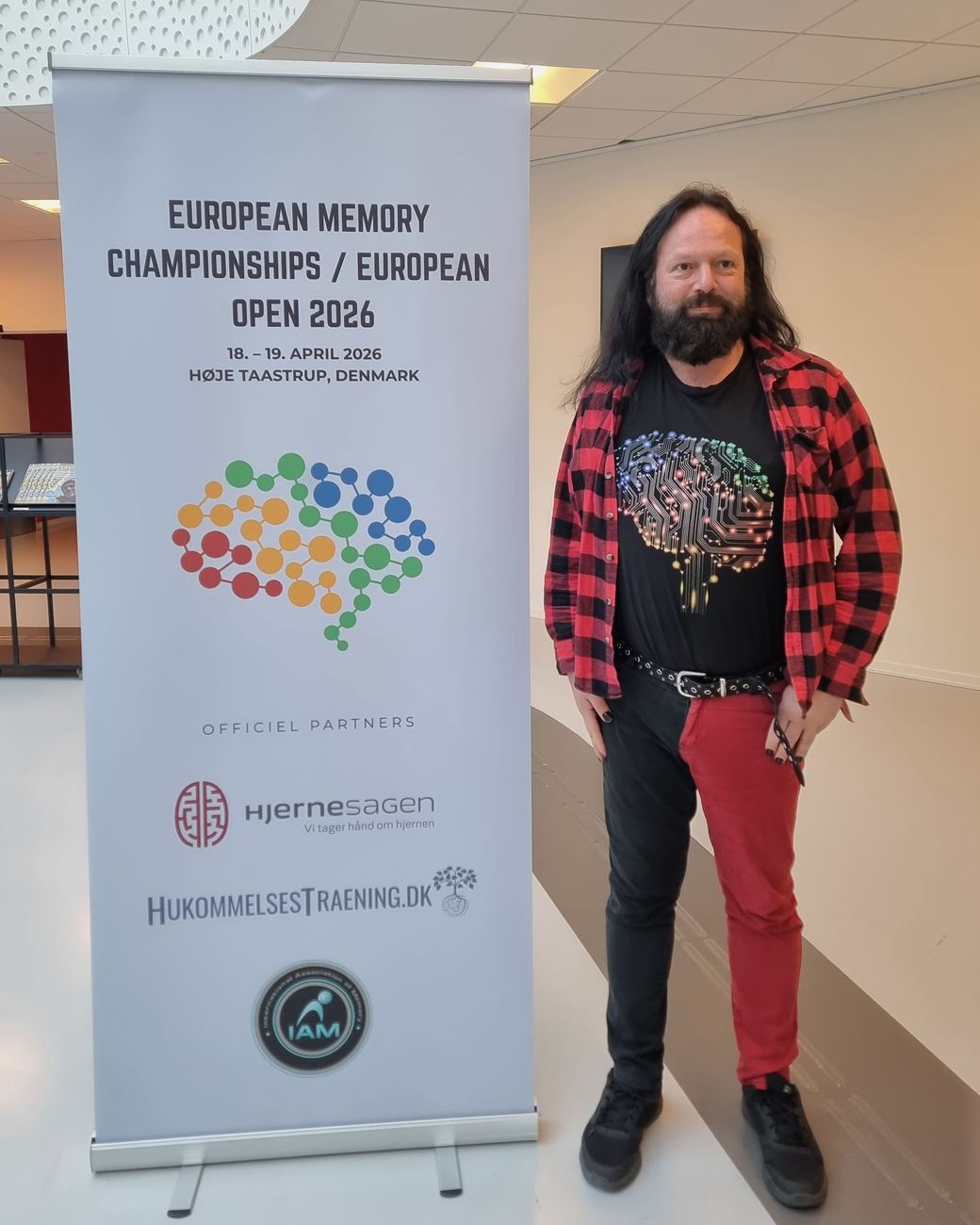 Frank Grube steht neben dem Aufsteller der European Memory Championships 2026 in Høje Taastrup, Dänemark.